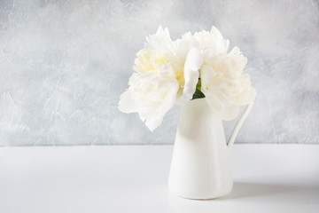 Beautiful bouquet of white peony flowers in vase. Copy space.