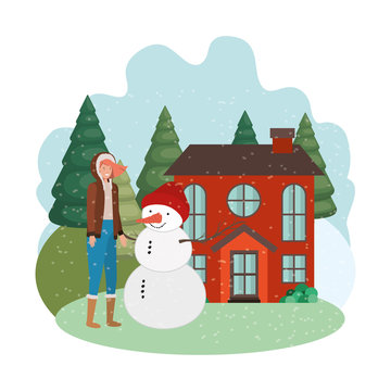 woman with snowman and house in winter