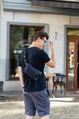 Young guy in round sunglasses posing on camera.