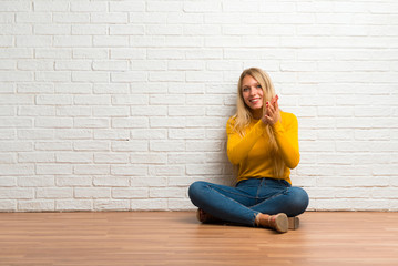 Young girl sitting on the floor applauding after presentation in a conference