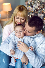 family with son sitting on the bed