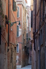 Fototapeta na wymiar Venice, Italy. Vertical view of narrow street scene in Venice