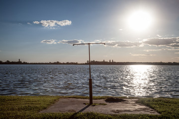 Rusty shower on a beach facing the Blue water of Palic Lake, in Subotica, Serbia, during a summer sunset Also known as Palicko Jezero, it is one of the main attractions of Vojvodina province.