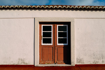 Red weathered wooden doors captured in Lisbon, Portugal