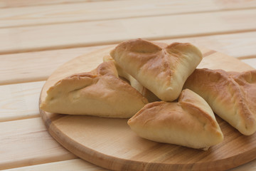 Bunch of fresh homemade pies on wooden board. Country house style. Authentically. Front view. Food photography concept