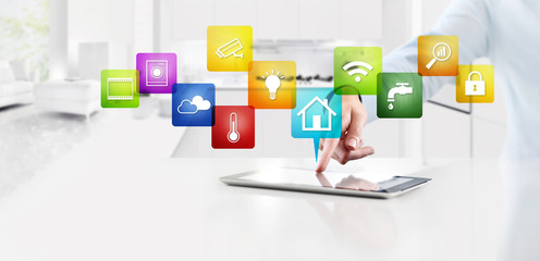 smart home automation control concept hand touch digital tablet screen with colored symbols icons on kitchen background web banner and copy space template