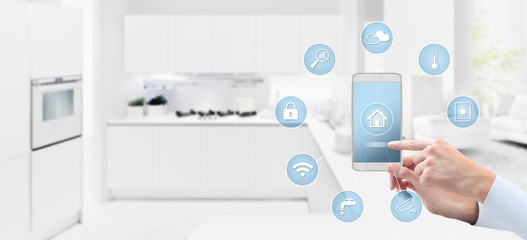 smart home automation control concept hand touch cell phone screen with blue symbols icons on kitchen background web banner and copy space template