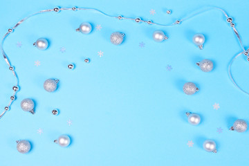 Many Christmas baubles on blue background.