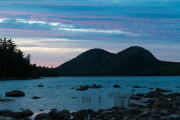 A landscape view of Jordan Pond during sunset in Acadia National Park in Maine.