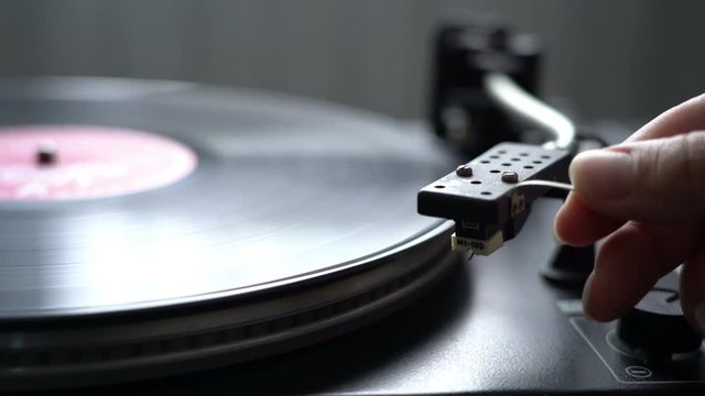 Cinemagraph Loop Vintage Vinyl Turntable Record Player with female hand holding niddle