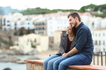 Couple in love contemplating views on a ledge