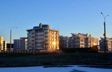 Buildings, houses, city building on the background of the evening sunset