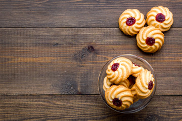 Homemade cookies. Kurabe in glass bowl on dark wooden background top view copy space