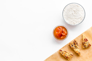 Ingredients for homemade cookies. Fresh cookies near flour on white background top view space for text