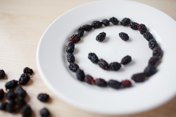 Dark berries on a white plate