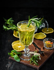 Hot white wine and rosemary cocktail. On a wooden background. Top view. Free copy space.