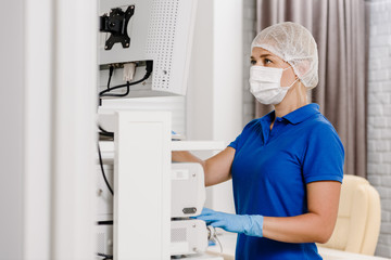 Naklejka premium Female operator of ultrasound scanning machine doing test for patient