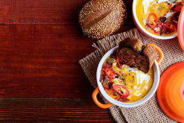 traditional pumpkin cream soup in a rustic style. healthy eating concept.