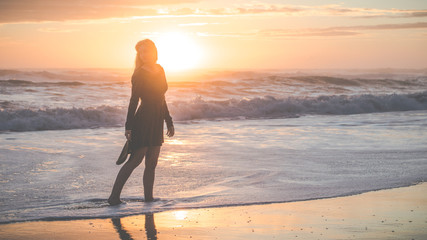 Woman on beach during sunrise
