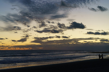 Fototapeta na wymiar The surf of Atlantic ocean in the Grand Canaria island at the blue sunset