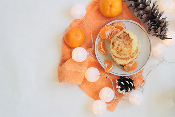 Flat lay food cheese pancakes on orange textile with fresh fruits. White background