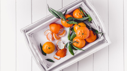 Clementines tangerines in a white tray