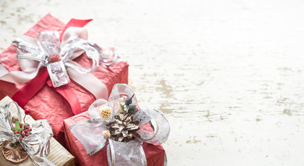 Holiday gift boxes on a light wooden background.
