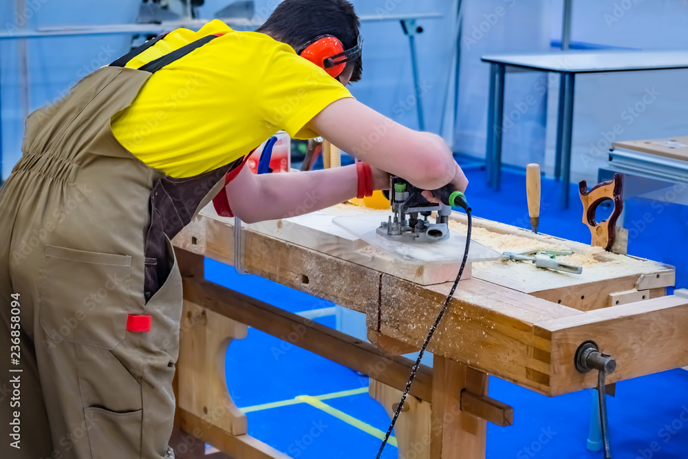 Poster a carpenter. milling machine. the carpenter works with a milling machine. workbench carpenter. carpe