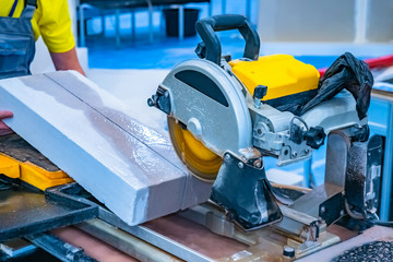 A man sawing concrete. Construction works. Cutting saw. Worker sawing stone cutting saw. Saw with a...