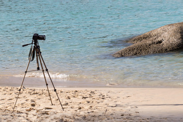 Camera installed on tripod by the sea ready for shooting and recording.Taking pictures.