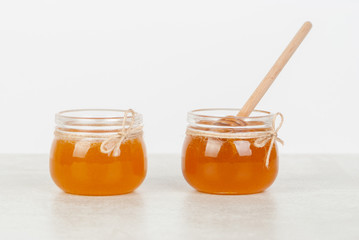 honey in jars on white table