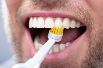 Close-up Of A Man Brushing Teeth