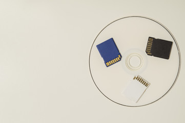Memory card and digital disc isolated on white background. sd card and cd macro. copy space