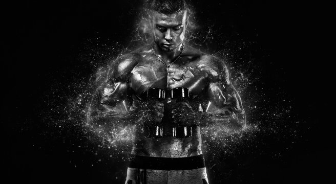 Muscular fitness sports man, atlete with dumbbell in fitness gym. Fire and power.