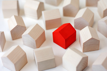 Many wooden houses with single red house in center