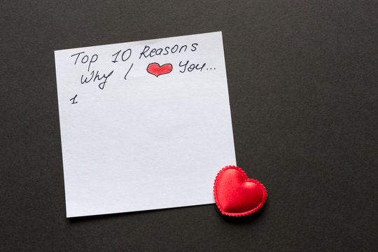 Reasons why I love you. White paper with red heart in the corner on black background. Valentine's day concept - lovely copy space for text.