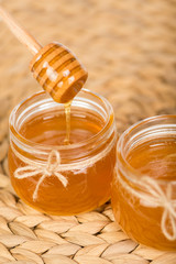 honey in jars on white table