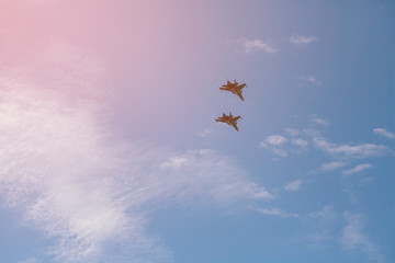 A group of combat aircraft high in the sky makes a demonstration at the air show. Two assault...