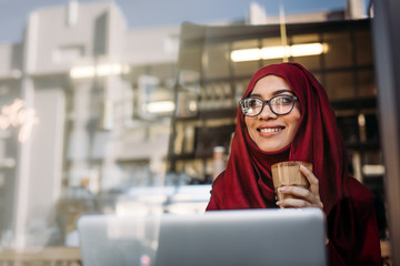 Beautiful muslim woman relaxing at cafe