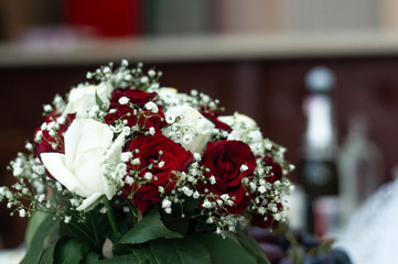 Bouquet of roses in bride hands. Weddind details in closeup view. Solemn event..