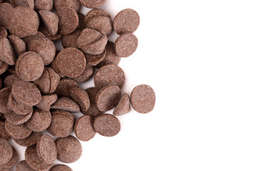 Pile of Unsweetened Carob Chips on a White Background