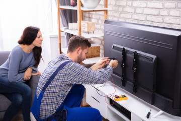 Technician Repairing Television
