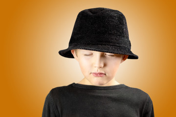 young boy with very calm, meditating and focused expression of his face and body gesture with free copy space for the text