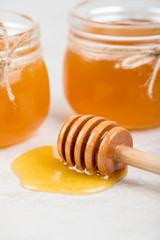 Fototapeta na wymiar honey in jars on white table