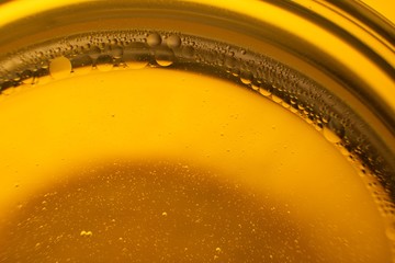 Yellow oil bubbles on water, cooking oil background.