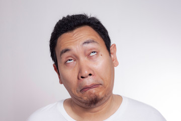 Obraz premium Funny Asian Man Lazy Bored Mocking Face