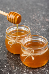 honey in jars on black table