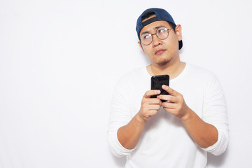 Young Man Thinking While Chatting on Smart Phone