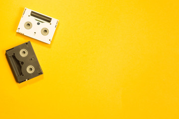 Digital video cassette on yellow background. mini cassette. copy space