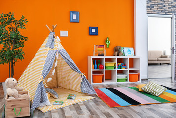 Cozy kids room interior with play tent and toys